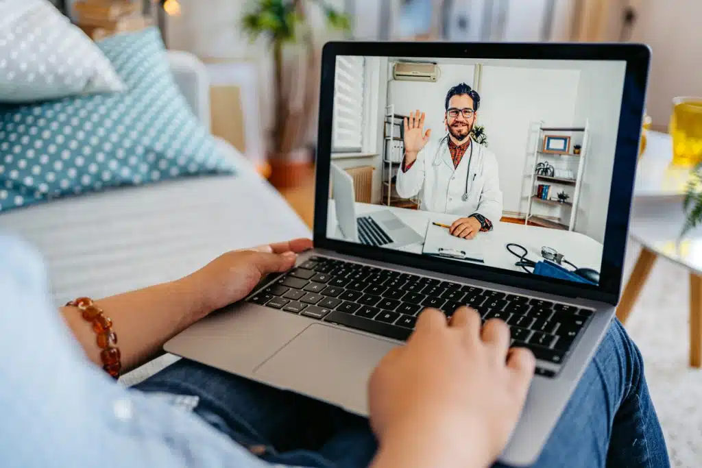 Young Woman Having A Doctor's Appointment Online At Home