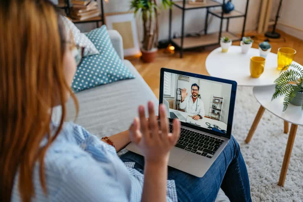 Young Woman Having A Doctor's Appointment Online At Home