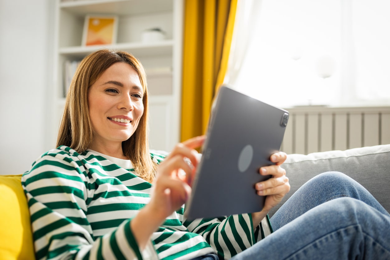 Young woman using digital tablet at home